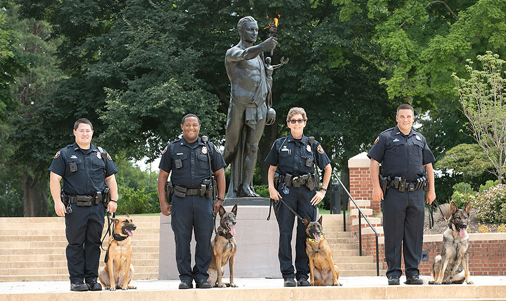 UTPD K-9s and officers at the Torchbearer statue