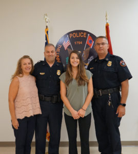 Victoria Brooks (second from right) with her parents Veronica and UTPD Lieutenant Scott Brooks, and UTPD Chief Troy Lane.