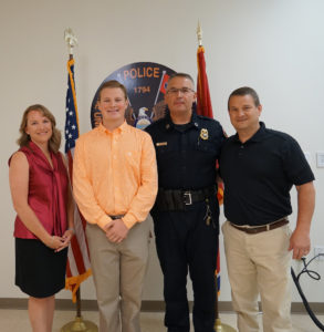 Ronald “RJ” Wade (second from left) with his parents Aimee and retired UTPD Officer Ron Wade, and UTPD Chief Troy Lane.