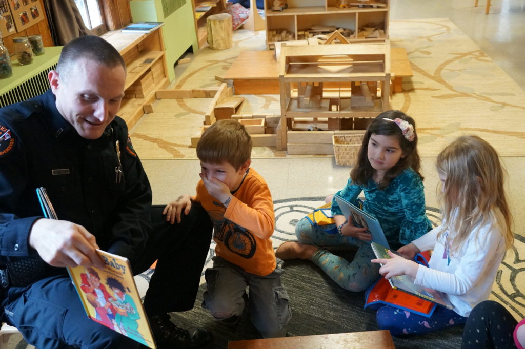 Officer Mike Williams reads to pre-kindergarten students at the UT Early Learning Center.