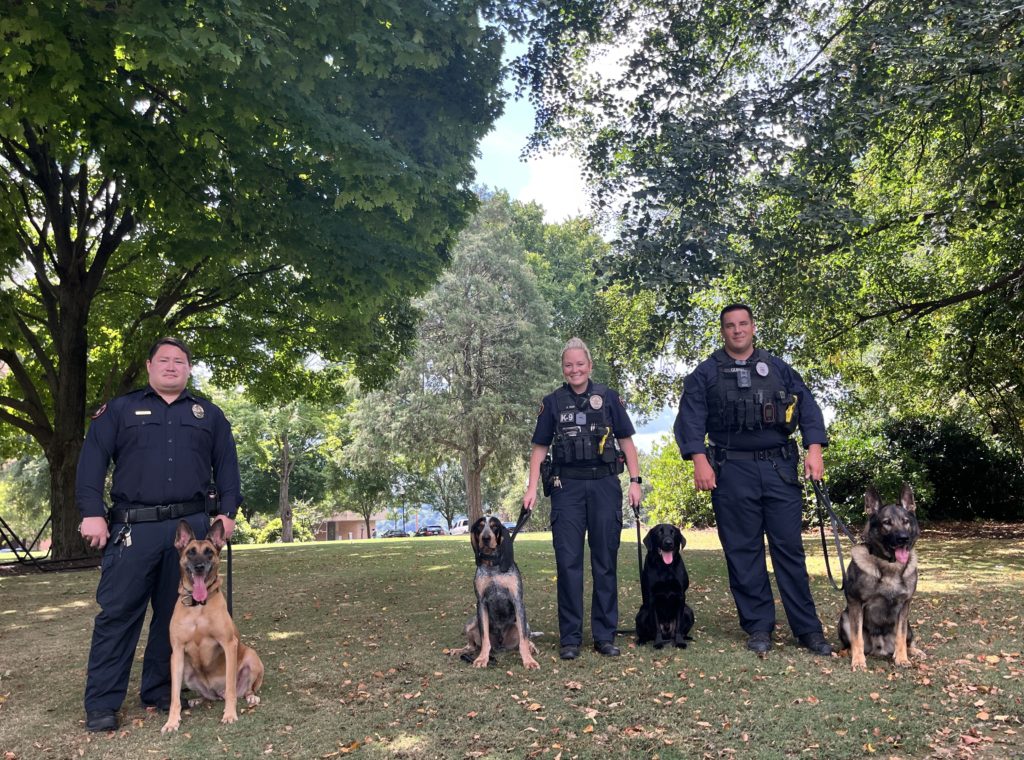 From left: K9 Athena with Sergeant Platt, Smokey XI, K9 Kale with Officer May, and K9 Bruno with Corporal Quirin