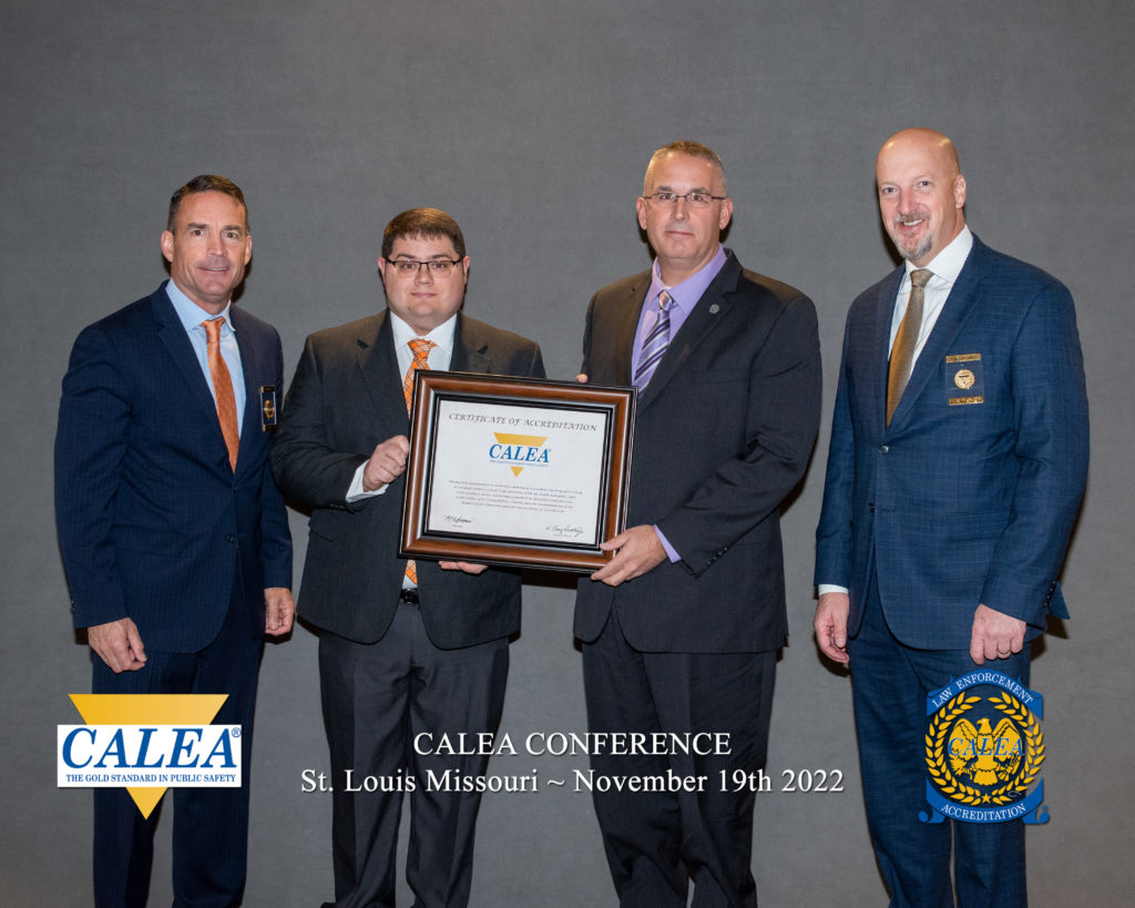 UT Accreditation Manager Allen Capps (second from left) and UTPD Chief Troy Lane (third from left) receive the reaccreditation award from CALEA officials